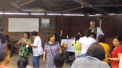 Columban Fr. Ed O'Connell and parishioners before Mass