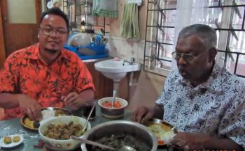 Fr. Kurt eating lunch with Uncle Bale